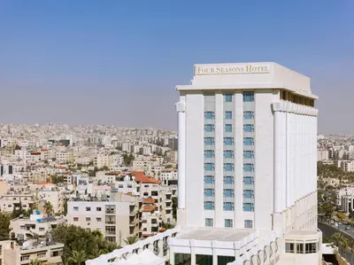a building with a sign on top of it at Four Seasons Hotel Amman in Amman