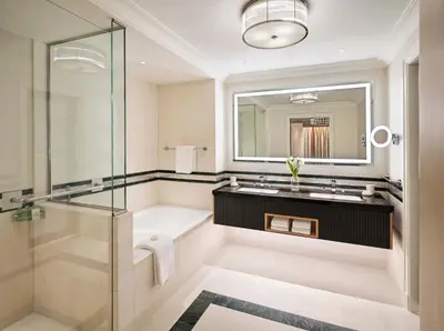 a bathroom with a tub and a sink and a shower at Four Seasons Hotel Amman in Amman