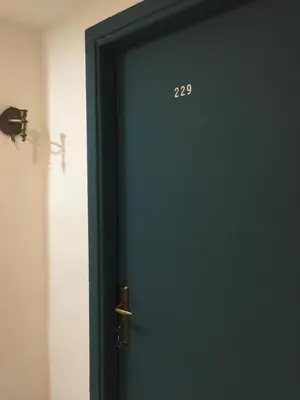 a blue door with the number on it at Nobel Hotel in Amman