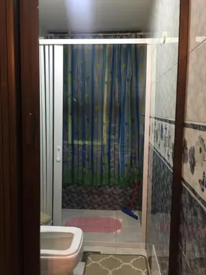 a bathroom with a shower with a toilet in it at Nobel Hotel in Amman