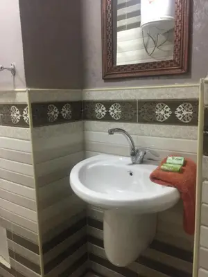 a bathroom with a sink and a mirror at Nobel Hotel in Amman