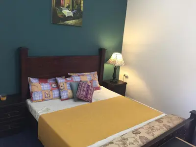 a bedroom with a bed with yellow sheets and pillows at Nobel Hotel in Amman