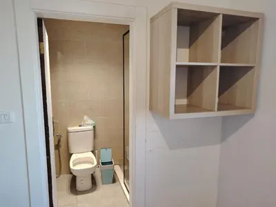 a small bathroom with a toilet and a cabinet at Abu alzoz home سكن مشترك in Amman
