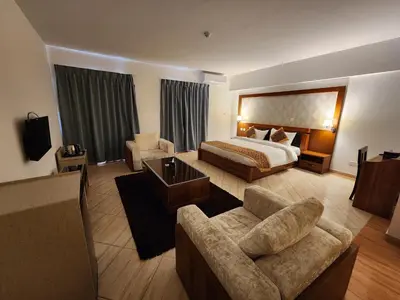a hotel room with a bed and a couch at Aquavista Hotel & Suites in Aqaba