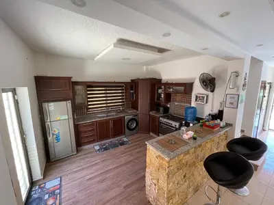 a kitchen with a refrigerator and a counter top at Orient Villa-Dead Sea in Sowayma