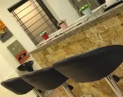 a black chair sitting in front of a counter at Orient Villa-Dead Sea in Sowayma