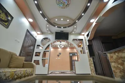 a lobby with a spiral staircase with a ceiling at Juniper House in Wadi Musa
