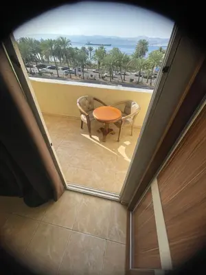 a view of a room with a table and chairs at Al Deyafa Hotel in Aqaba