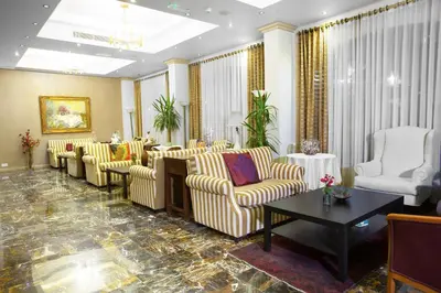 a lobby with couches and chairs and a table at Grand Hotel Madaba in Madaba