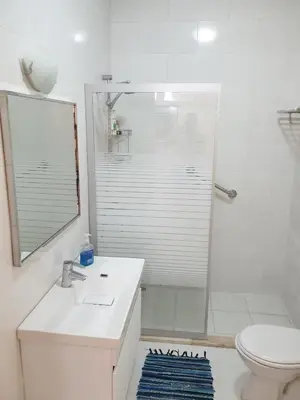 a bathroom with a toilet and a sink and a shower at Sea View Apartment at Tala Bay Resort in Aqaba in Aqaba
