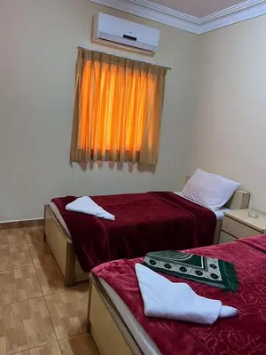 a hotel room with two beds and a window at Dweik Hotel 1 in Aqaba