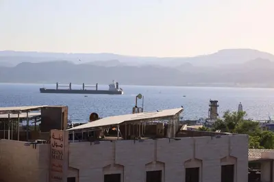 a view of the ocean with a large ship in the water at Dweik Hotel 1 in Aqaba