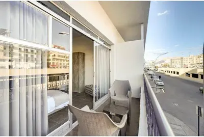 a room with a balcony with a bed and a bedroom at Hotel magic aqaba in Aqaba