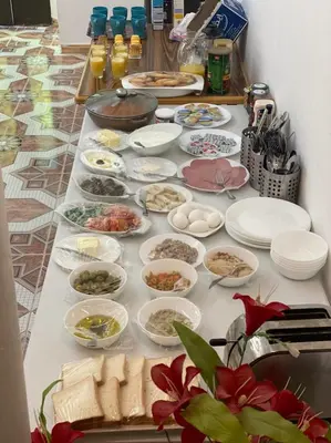 a table with many plates and bowls of food at Jordan Guest House in Wadi Musa