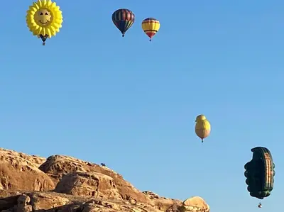 a group of hot air balloons in the sky at Jordan Guest House in Wadi Musa