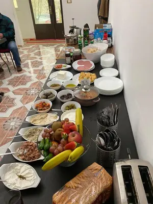 a table with a bunch of food on it at Jordan Guest House in Wadi Musa