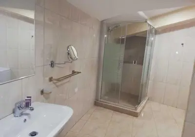 a bathroom with a shower and a sink and a shower at Shami Plaza Hotel in Amman