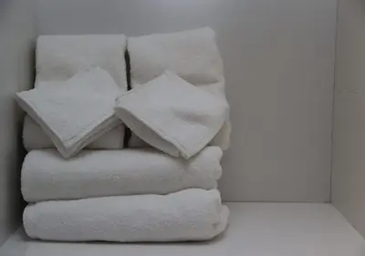 four towels stacked on top of each other in a room at Shami Plaza Hotel in Amman