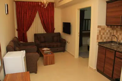 a living room with a couch and a chair at Shami Plaza Hotel in Amman