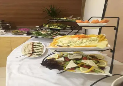 a buffet with several plates of food on a table at Shami Plaza Hotel in Amman