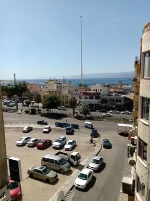 a parking lot with cars parked in a parking lot at seven7days hotel in Aqaba