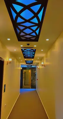 a hallway with a ceiling with a blue light at Shaqilath Hotel in Wadi Musa