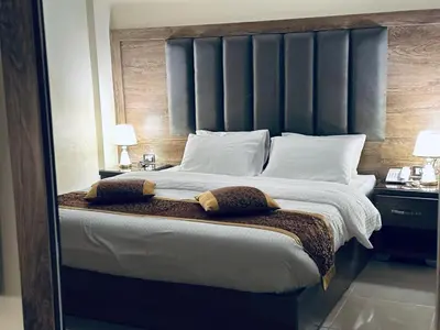 a bedroom with a large bed with a large headboard at Shaqilath Hotel in Wadi Musa