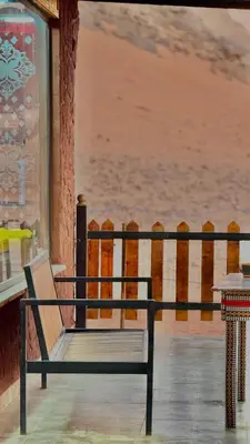 a bench sitting on a porch looking at the ocean at Rum Paradise luxury camp& BUBBLE in Wadi Rum