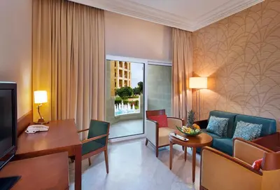 a living room with a couch and a table at Crowne Plaza Jordan Dead Sea Resort & Spa by IHG in Sowayma