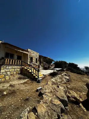 a house on top of a hill with rocks at Jabal Dana Hotel - the highest hotel in Jordan in Dana