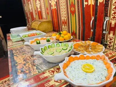 a buffet with bowls of food on a table at Wadi Rum Magic Nature Camp in Wadi Rum