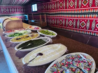 a buffet with many plates of food on a counter at Wadi Rum Magic Nature Camp in Wadi Rum