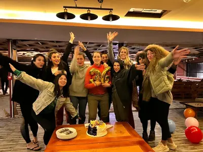 a group of people standing in front of a table with a cake at Petra Wassaif Camp in Wadi Musa
