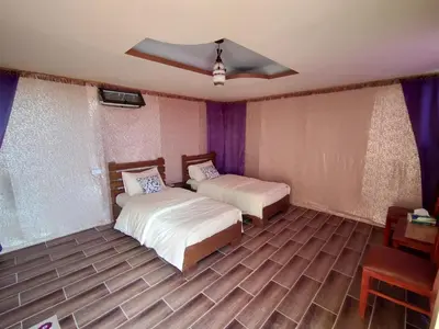 a bedroom with two beds and a ceiling at Petra Wassaif Camp in Wadi Musa