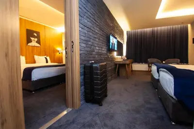 a hotel room with two beds and a tv at Monarch Hotel Amman in Amman