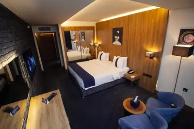 a hotel room with a bed and a tv at Monarch Hotel Amman in Amman