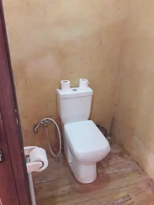 a bathroom with a toilet with two rolls of toilet paper at Magic Wadi Rum in Wadi Rum