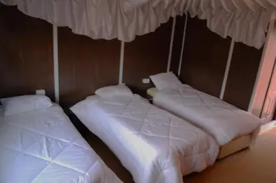 two beds sitting next to each other in a room at Magic Wadi Rum in Wadi Rum