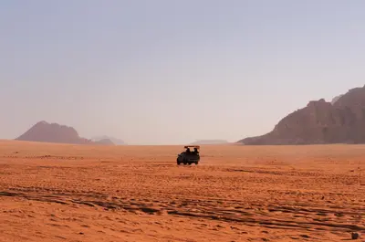 a jeep in the middle of the desert at Magic Wadi Rum in Wadi Rum