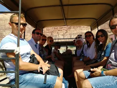 a group of people sitting in a bus at Wadi Rum Excursions in Wadi Rum