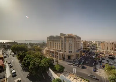 an aerial view of a city street with a building at Shweiki International Hotel in Aqaba