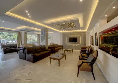 a large living room with couches and a fish tank at Shweiki International Hotel in Aqaba