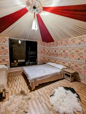 a bedroom with a bed and a ceiling at Desert Magic Camp & Resort in Wadi Rum