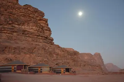 a group of buildings in front of a mountain at Desert Magic Camp & Resort in Wadi Rum