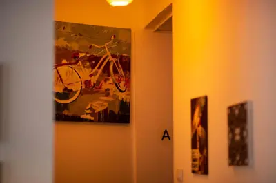 a painting of a bike hanging on a wall at The Cabin in Amman