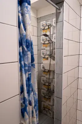 a bathroom with a shower curtain and a sink at The Cabin in Amman