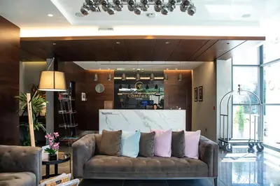 a living room with a couch with pillows on it at The Compass Hotel in Amman