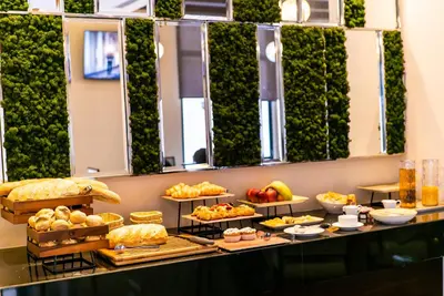 a buffet line with different types of bread and pastries at The Compass Hotel in Amman
