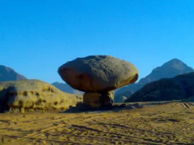 a large rock sitting on top of a mountain at Wadi Rum Old Bedouin Camp in Wadi Rum
