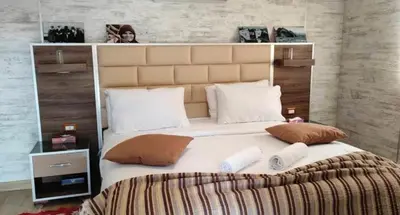 a large bed with a large headboard in a bedroom at Seven Wonders Luxury Camp in Wadi Musa